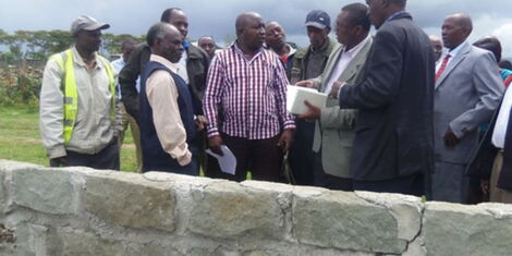 Laikipia East MP Anthony Mutahi (in striped shirt) during the inspection of a classroom under construction at Kariguini Secondary School in his constituency in 2015.