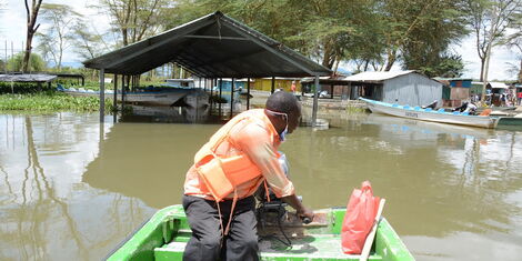 A boat operator assesses damage at Lake Naivasha's Kamere landing beach in May 2020