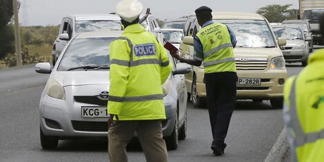 Traffic police officers stop motorist at a checkpoint. On Wednesday, May 13, 2020, NTSA issued a warning to motorists.