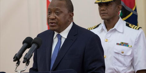 File image of President Uhuru Kenyatta with his personal aide Timothy Lekol